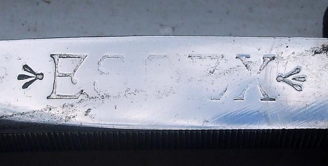 black oval ES..X inscription 8